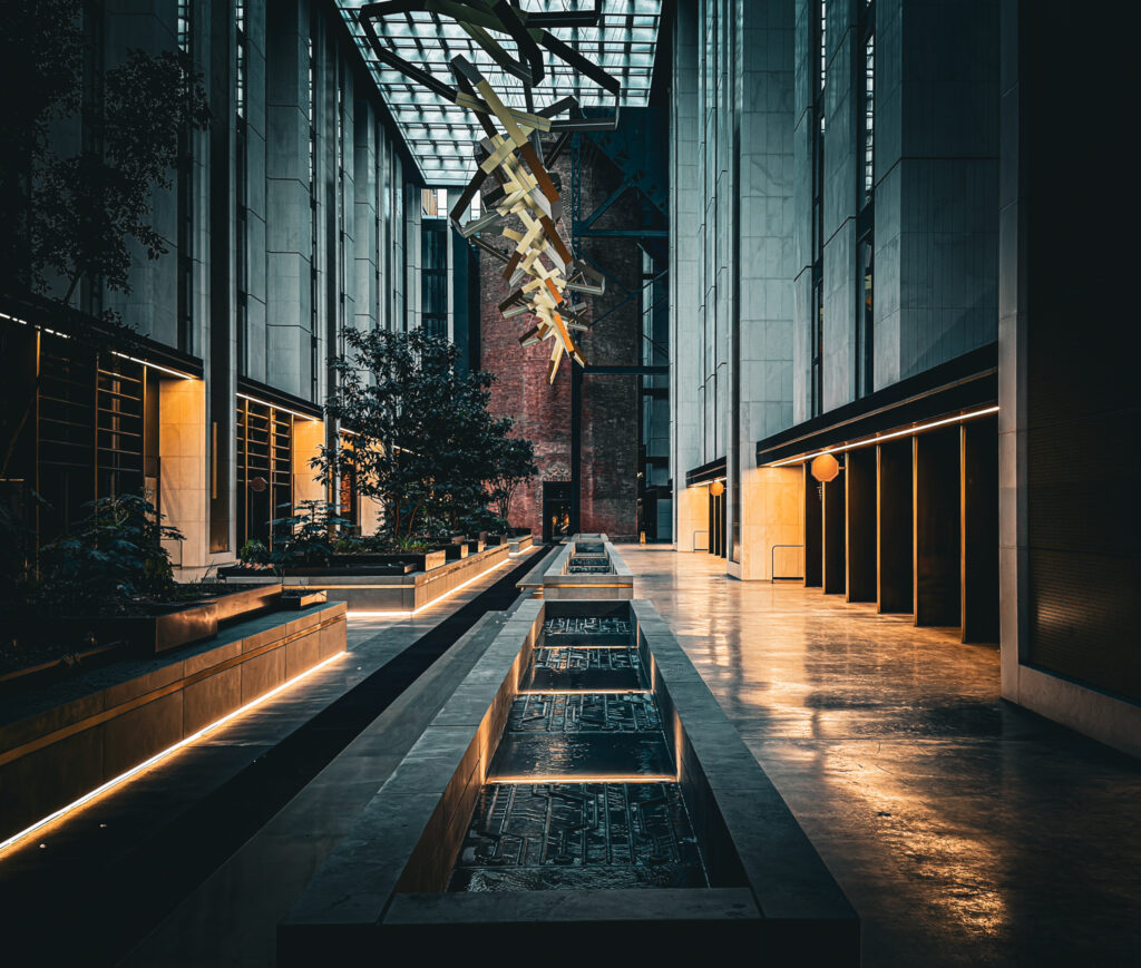 Chelsea Waterfront walkway with a water feature and hanging lights.